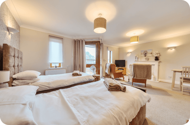 Cozy interior room with twin beds and seating area