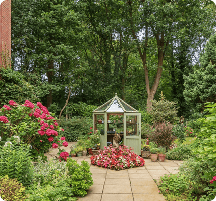 Beautiful garden with flowers and a greenhouse