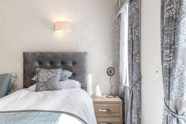 Bright private room with a bed and decorative curtains