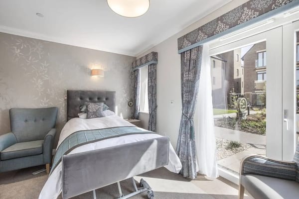 Brightly lit resident room with a view of the garden