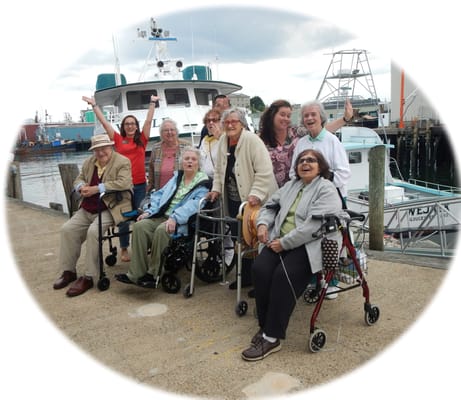Residents posing happily on an outdoor pier