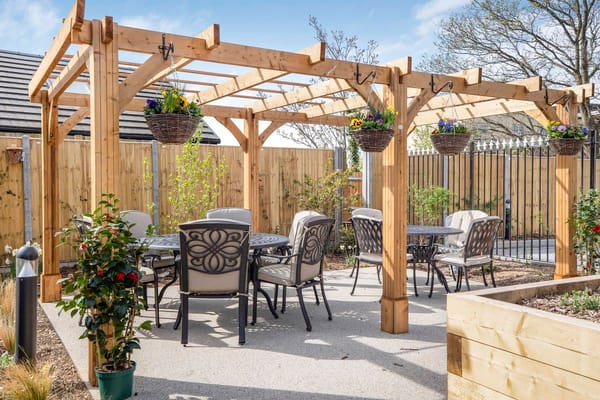 Outdoor dining area with seating and decorative plants
