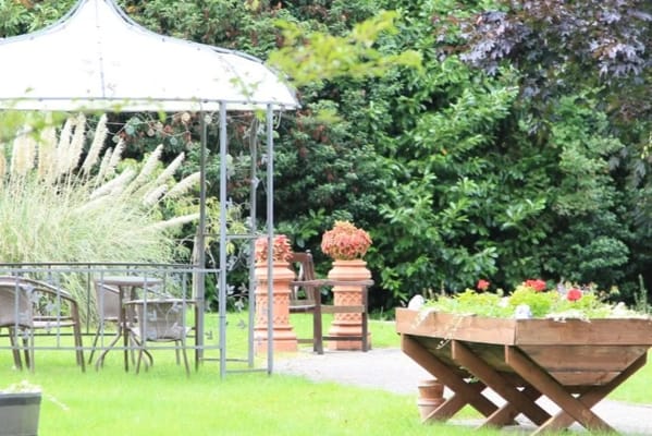 Outdoor garden area with seating and flowers
