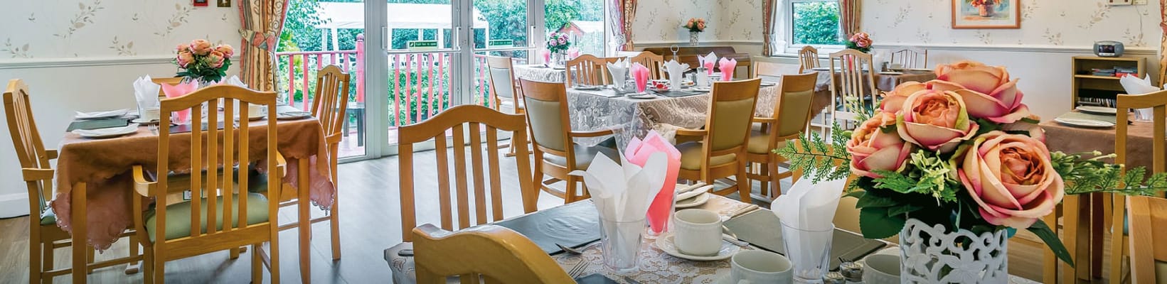 Dining area set up for a meal with flowers