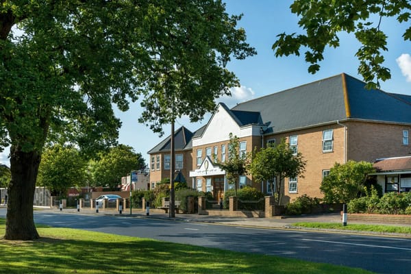 Exterior view of Cavell Lodge with surrounding greenery