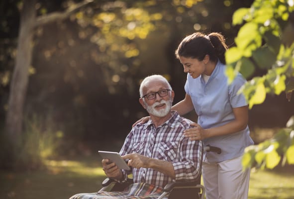 Caregiver assisting a resident in a garden