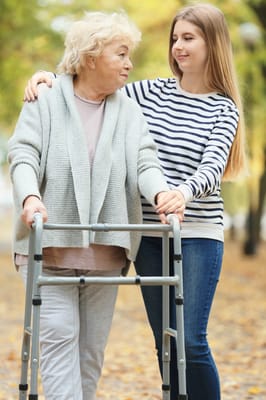 A caregiver assisting a resident outdoors