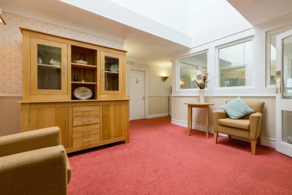 Common area with seating and wooden cabinet
