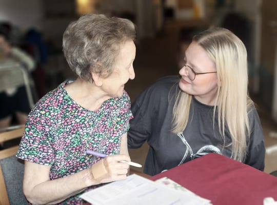 Two women engaged in conversation at a table