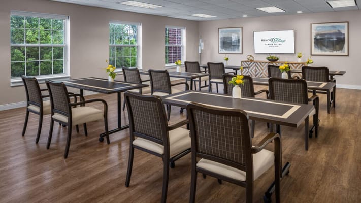Bright and clean common area with tables and chairs