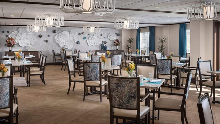 Brightly lit dining room with elegant decor and seating