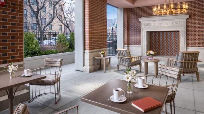 Outdoor seating area with flowers and coffee cups