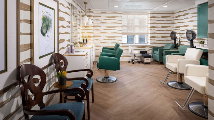 Bright salon area with styling chairs and mirrors