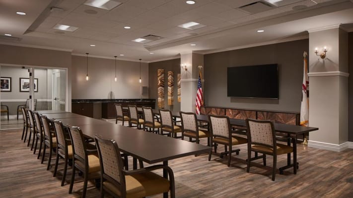 Bright common area with tables and chairs arranged