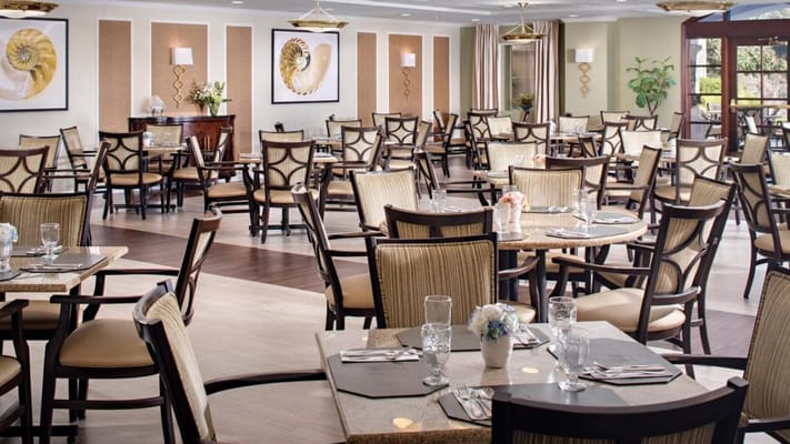 Elegant dining room with tables set for meals