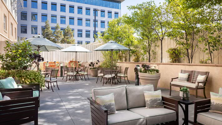 Outdoor seating area with tables and umbrellas