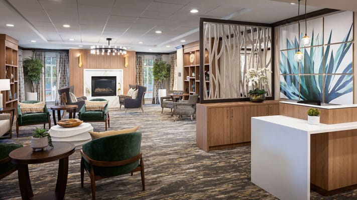 Bright common area with seating and a fireplace