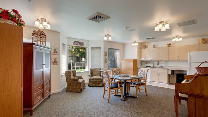 Bright common area with seating and a piano