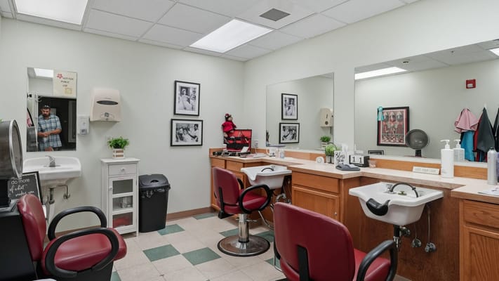 Bright hair salon area with chairs and mirrors