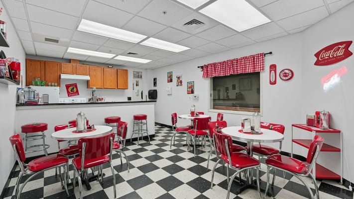Bright dining area with red chairs and tables