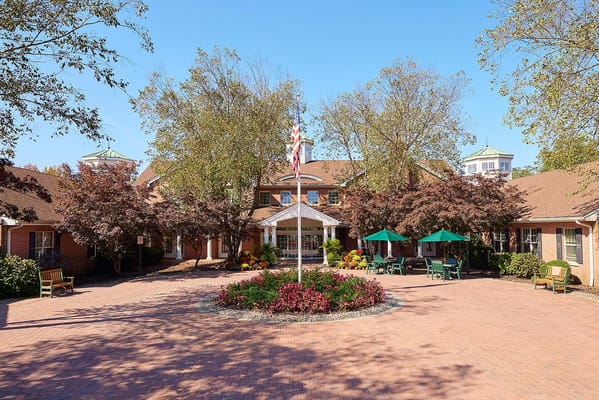 Exterior view of a senior living facility with gardens