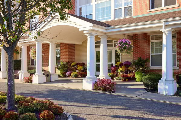 Welcoming exterior entrance adorned with colorful flowers