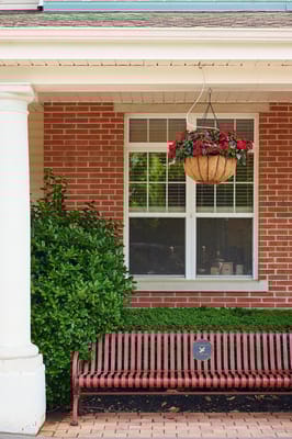 Outdoor seating area with flowers and greenery