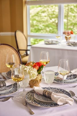 Elegant dining setup with wine and flowers