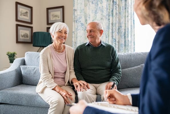 Elderly couple sitting on a couch in a cozy living area