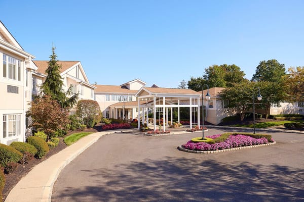 Exterior view of assisted living facility with blooming flowers