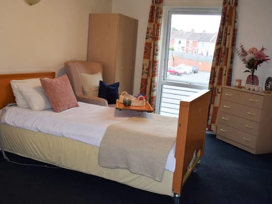A private room in the assisted living facility with a bed and window