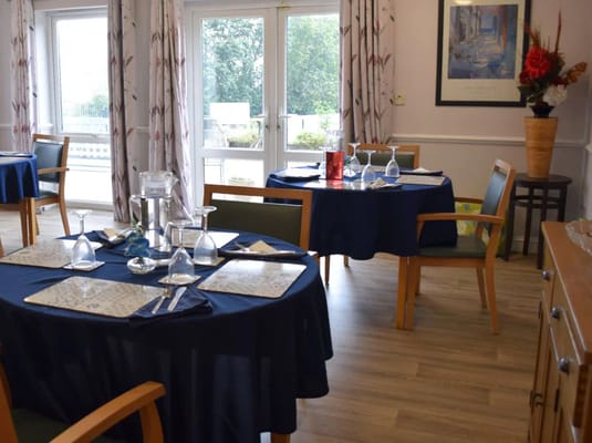 Dining room setup with tables and chairs