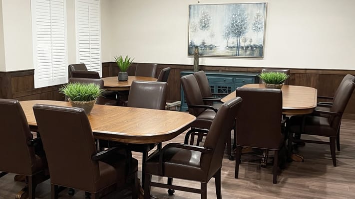 Common area with tables and chairs arranged for activities