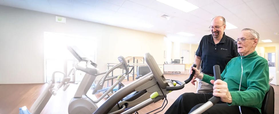 Resident engaging in physical activity with staff guidance