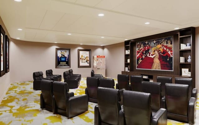 A cozy screening room with leather chairs and movie posters