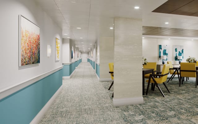 Bright common area with dining tables and paintings