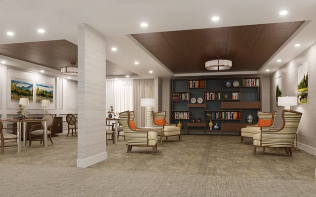 A modern common area with seating and bookshelves
