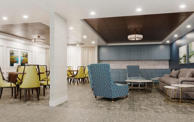 A bright common area with seating and tables