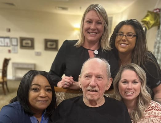 Staff and residents smiling together