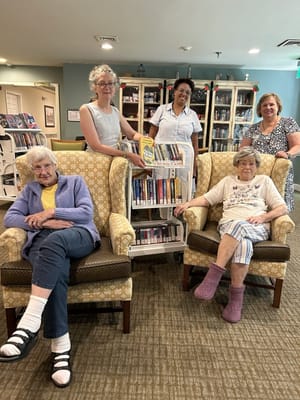 Residents and staff in a bright library area