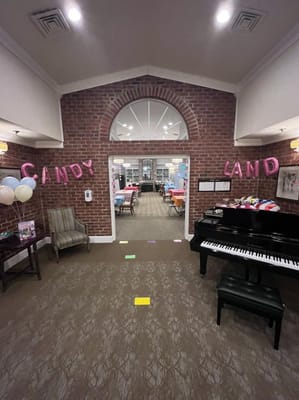A decorated common area with a piano and colorful decorations