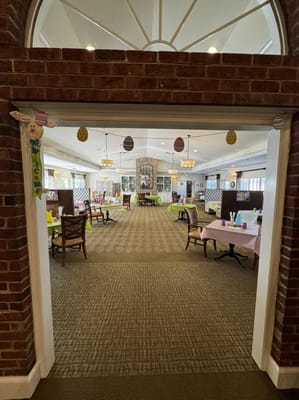 View into a decorated common area with tables and chairs