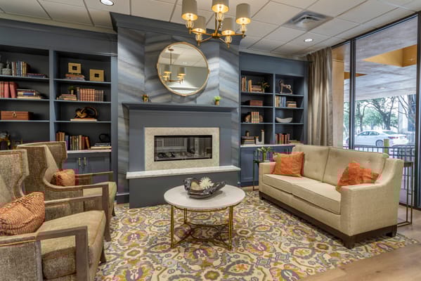 Cozy common area with comfortable seating and bookshelves