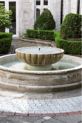 A decorative fountain in an outdoor garden space