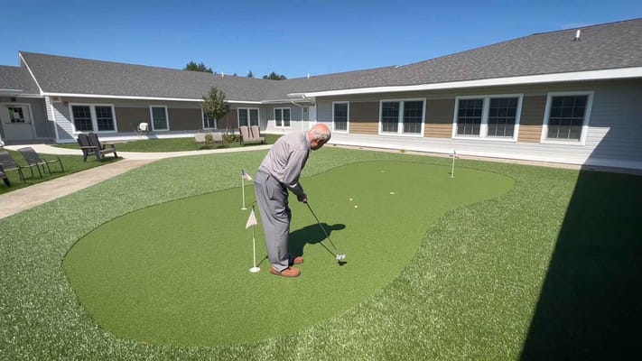 Senior playing mini-golf in an outdoor area