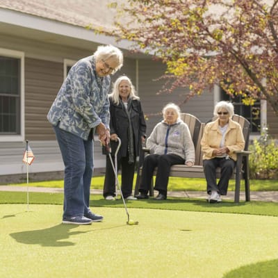 Residents enjoying mini-golf activity outdoors