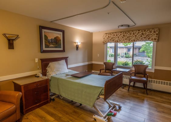 A well-furnished resident room with a view of the garden