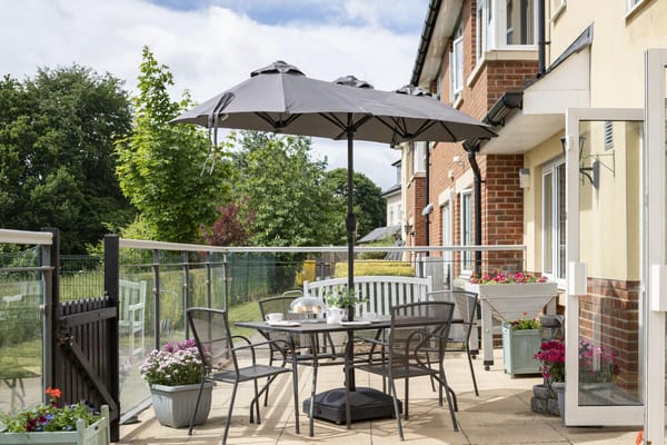 Outdoor seating area with tables and umbrellas