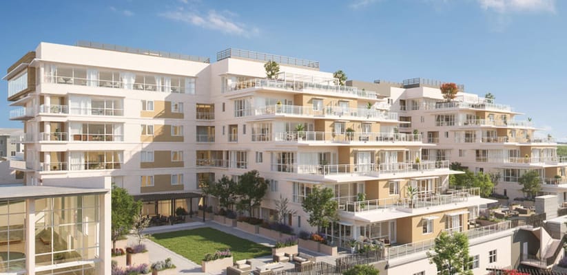 Exterior view of a modern senior living facility with gardens