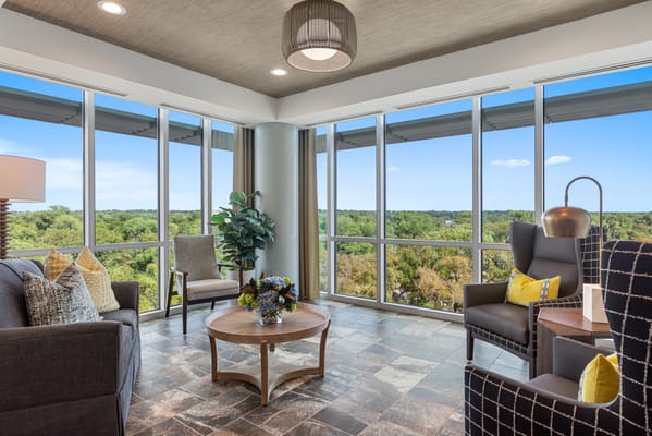 Bright common area with large windows and modern seating